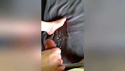 Busty woman gives a handjob on her boyfriend on feet