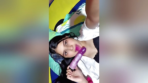 Brunette girl with big boobs is playing with toy in bathroom