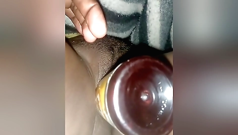 A girl is playing with her hairy pussy with a dildo