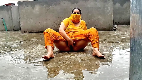 Indian girl enjoys the rain in her amateur solo video