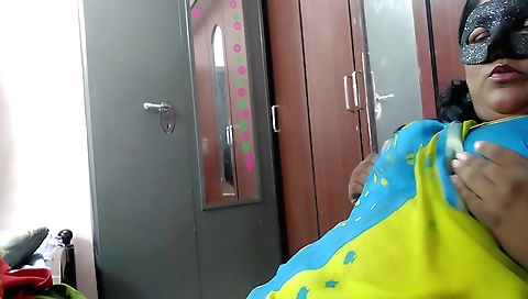 A mature woman is showing off her big boobs and ass