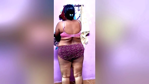 Indian brunette is making love with herself in bed