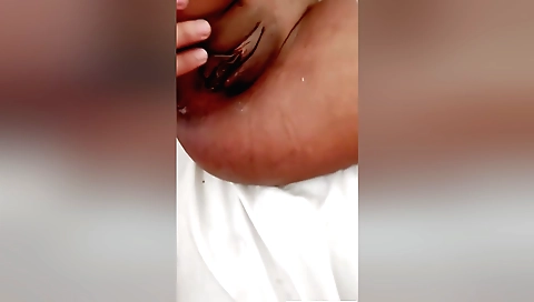 Indian girl fucks her hairy pussy on the bed in a porn video