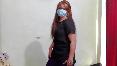 Cute redhead girl in red lingerie is playing with a toy